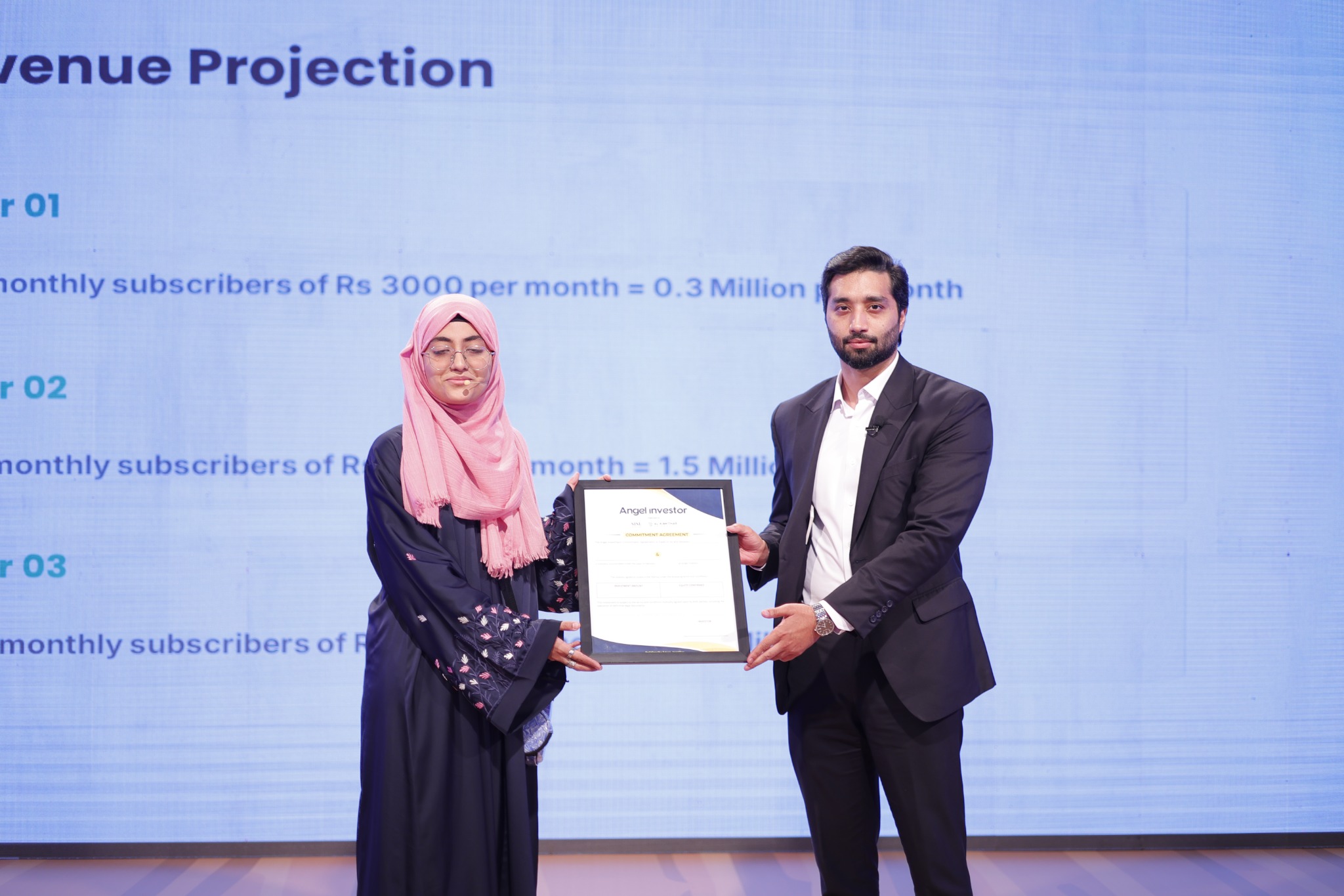 Founder receiving an investment commitment at the event